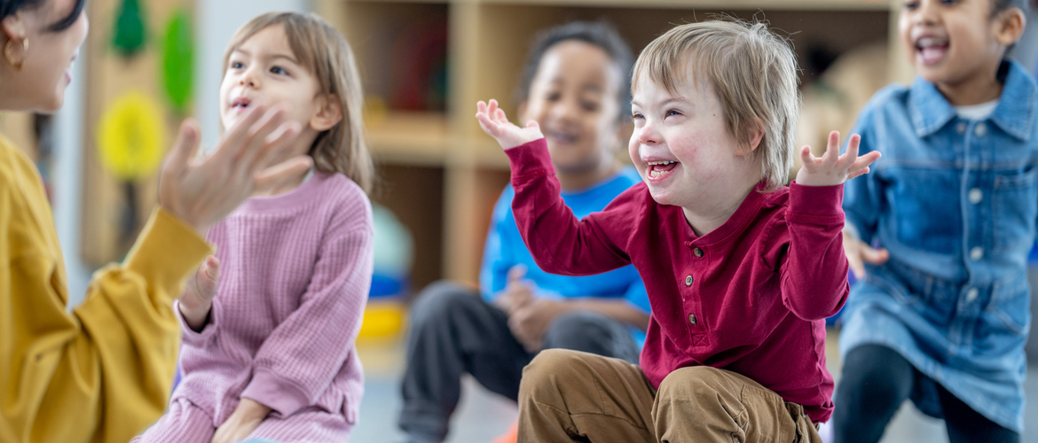 young people in nursery smiling 