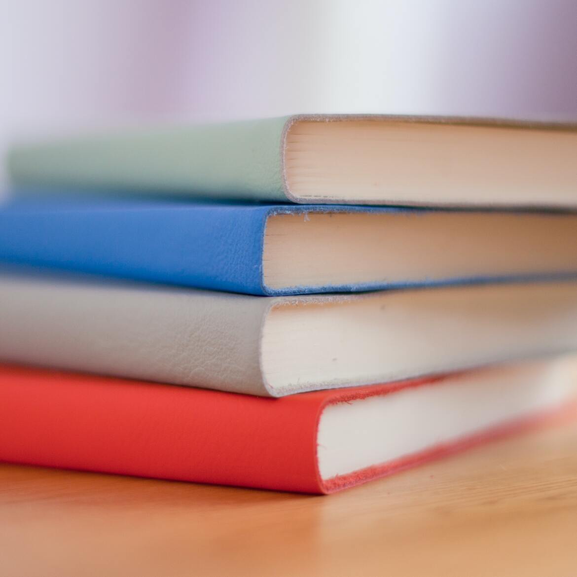 Four books stacked in a pile