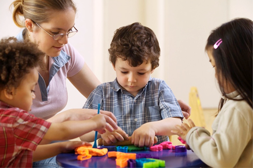 Children playing with a teacher