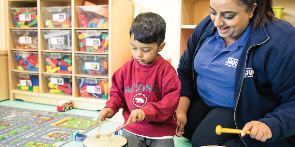 Child in early years setting playing with practitioner