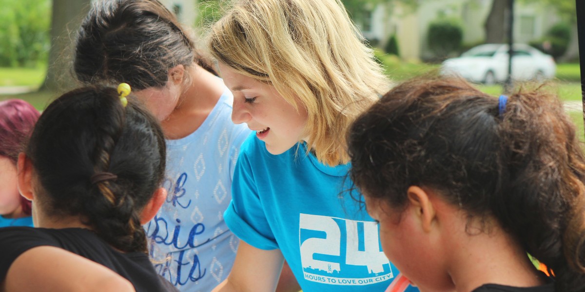 Woman with a group of children in outdoor setting